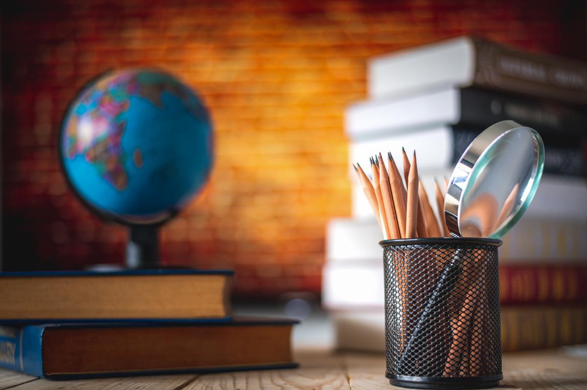 Picture shows basket of pencils in front of globe